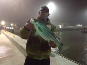 Mike and his keeper he released striped bass, indian river coast guard station