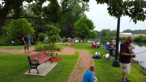 Kids fishing the park with their parents