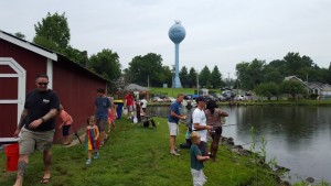 Kids fishing the park with their parents