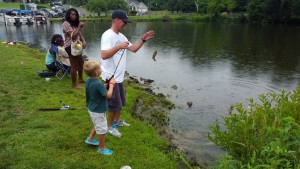 Kids fishing the park with their parents